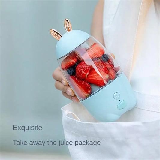 Clarify.pk portable electric juicer in light blue with fruit inside held by hand