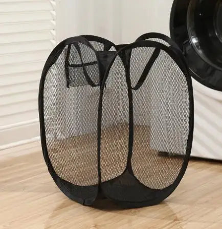Clarify.pk black mesh foldable laundry basket with handles placed on wooden floor near washing machine