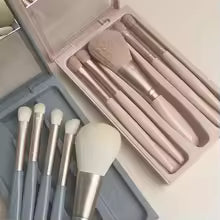 Compact mini makeup brush set with case featuring soft bristles in pastel colors for precise application