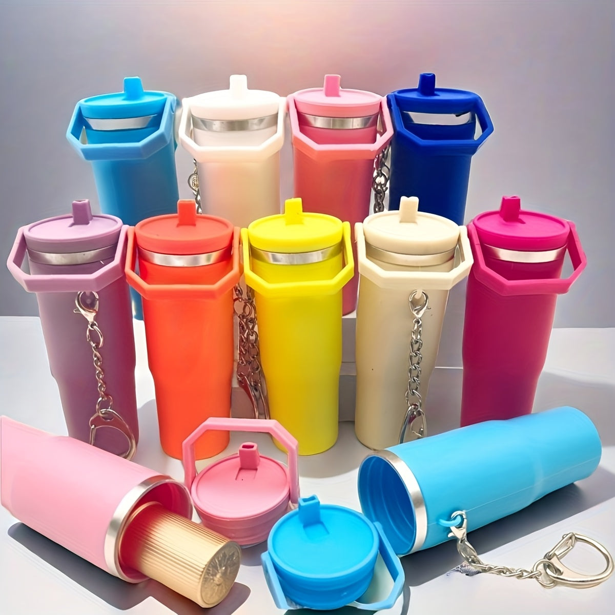 Colorful mini tumbler keychain collection with various bright colors and silver chain attachments for easy carrying