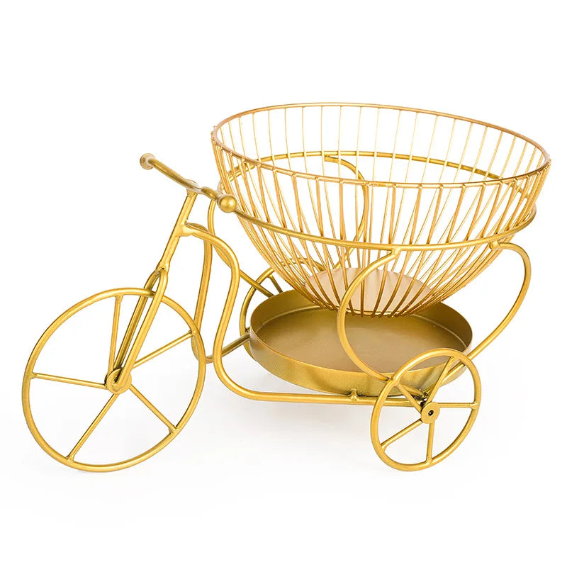 Gold metal modern fruit basket designed as a decorative tricycle with wireframe basket