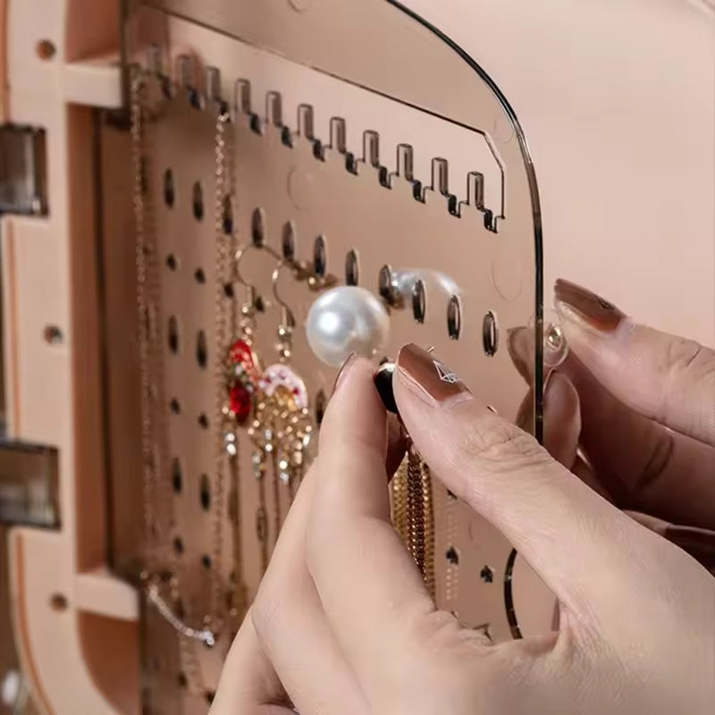 Close-up of hands organizing jewelry on a modern jewelry storage box with drawers by Clarify.pk