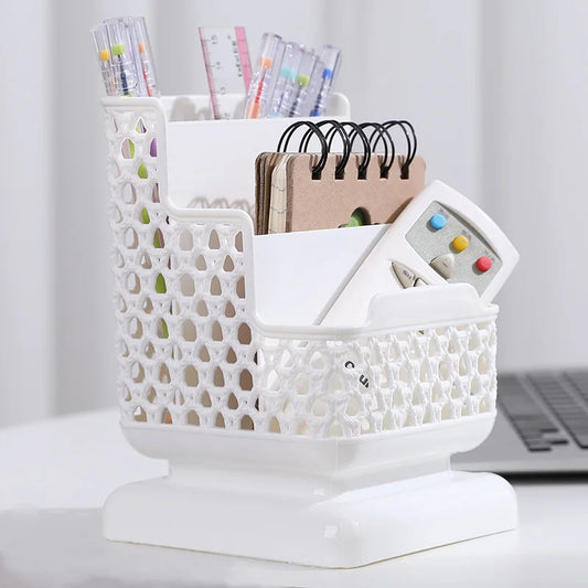 Clarify.pk white multi compartment desk organizer holding pens, notebook, and remote control on a desk