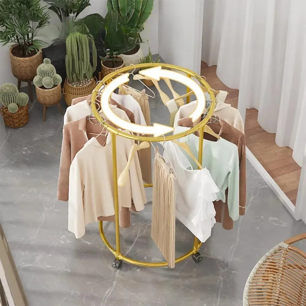 Clarify.pk multi functional coat hanger for clothes in gold metal, holding various garments in a living room setting
