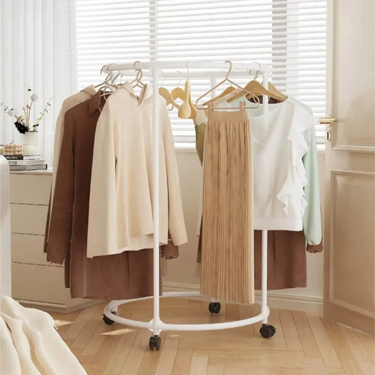 White multi functional coat hanger for clothes with wheels holding jackets and skirts in living room