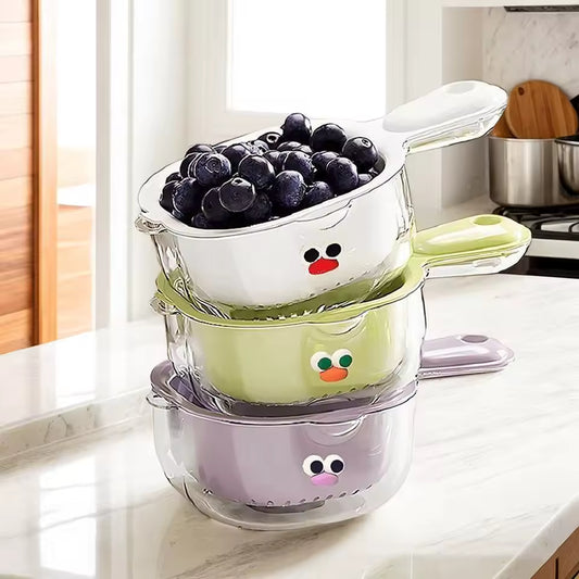 Stacked colorful multi-functional drain basket set with handles holding fresh blueberries on kitchen counter