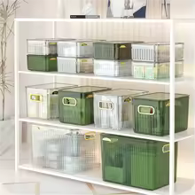 Multi-purpose household storage box set in green and clear colors organized on white shelving unit