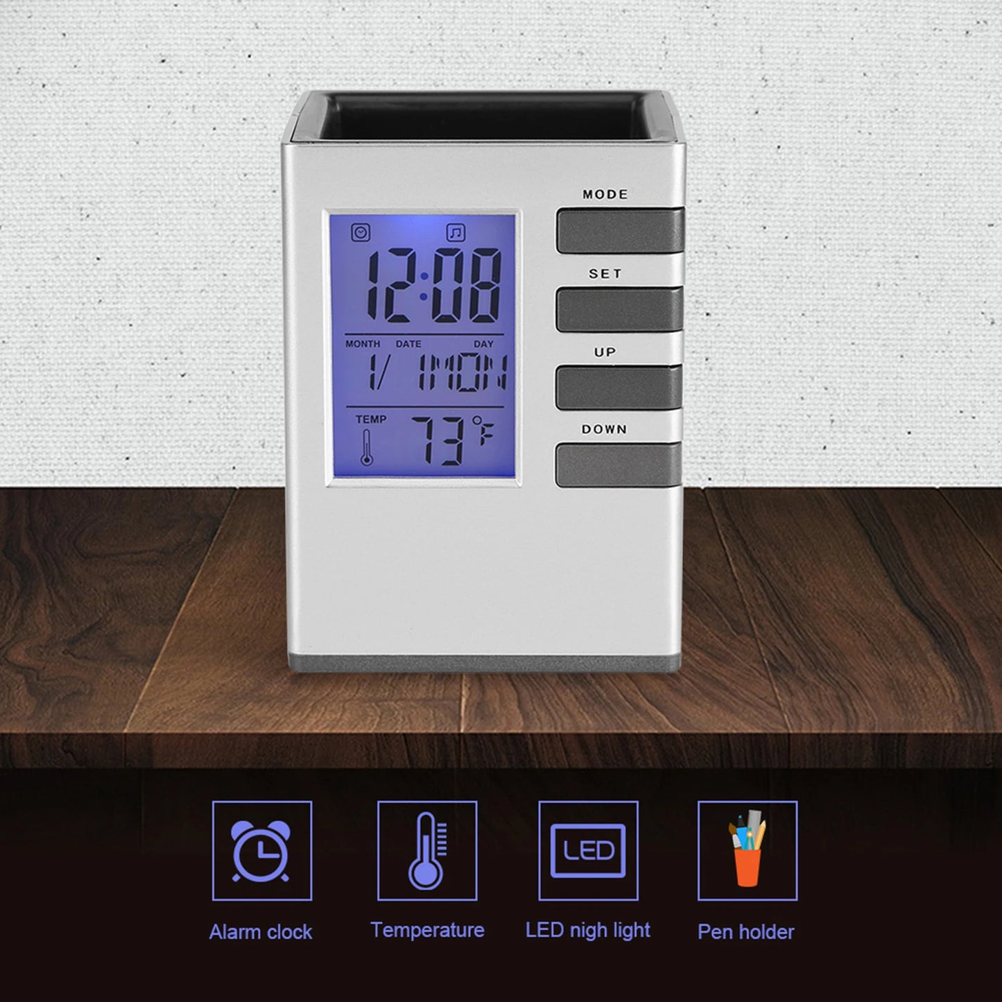 Multifunctional alarm clock with pen holder showing time temperature and LED night light on wooden surface