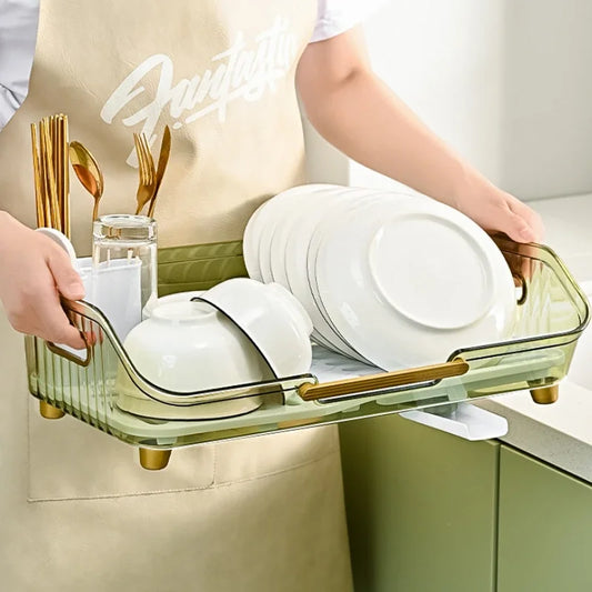 Clarify.pk multifunctional dish drainer with utensil holder in green glass holding white plates bowls and gold cutlery