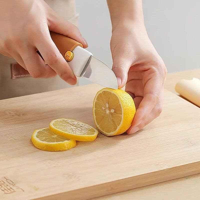 Clarify multifunctional fruit knife peeler slicing fresh lemon on a wooden cutting board