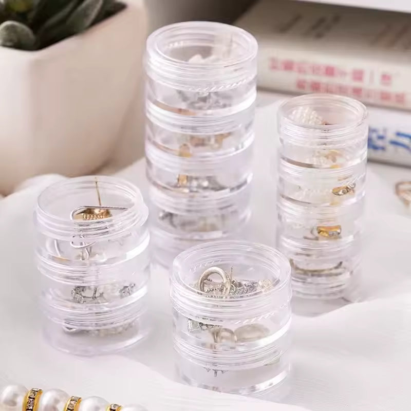 Clear 5 layer jewelry storage box from Clarify.pk holding various rings and earrings neatly