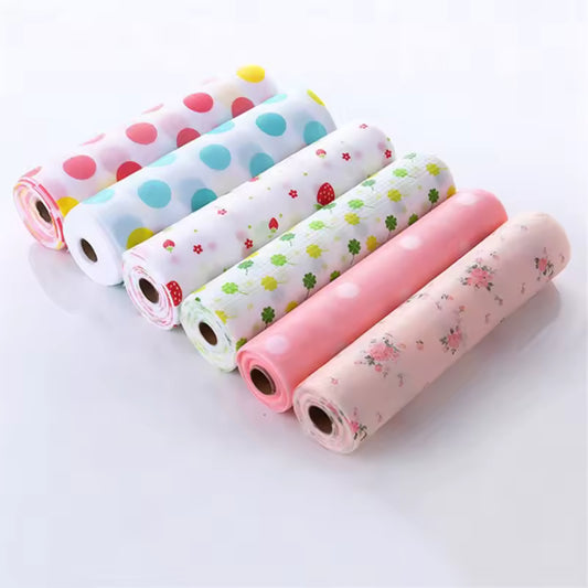 Rolls of colorful non-slip cabinet mat for drawers with various patterns including polka dots and floral designs