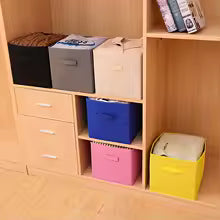 Colorful non-woven storage basket with handle arranged in wooden shelving unit for home organization
