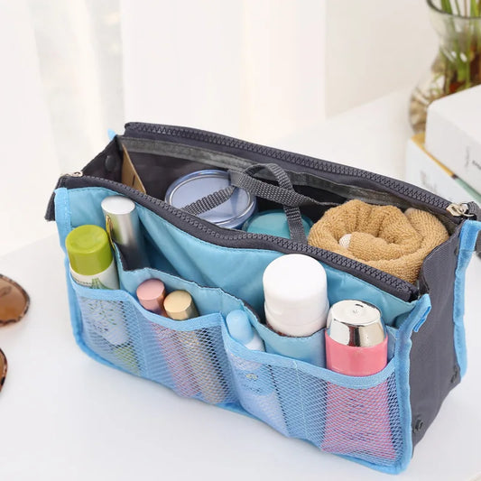 Clarify.pk nylon handbag organizer insert in blue with multiple compartments holding toiletries and cosmetics