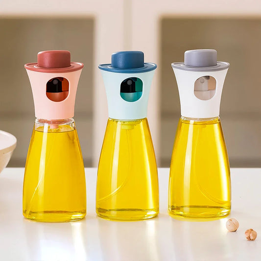 Clarify.pk oil sprayer for kitchen in pink blue and white with glass bottles filled with cooking oil
