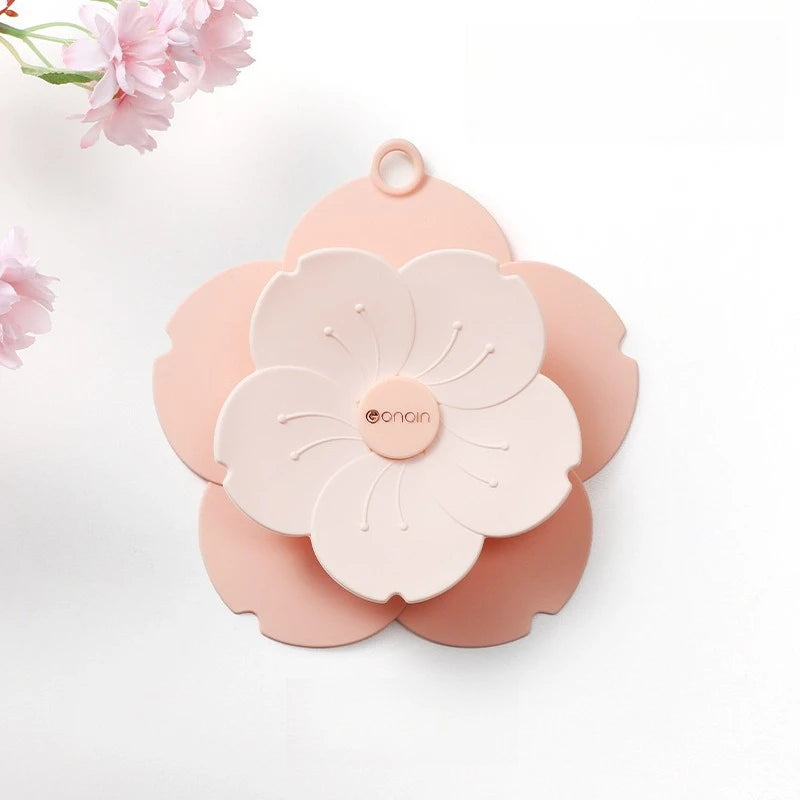 Pink flower-shaped silicone drain cover for bathroom with floral design by Clarify.pk