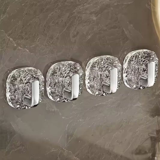 Pack of 4 self adhesive wall hooks with clear textured bases and silver hooks on gray surface