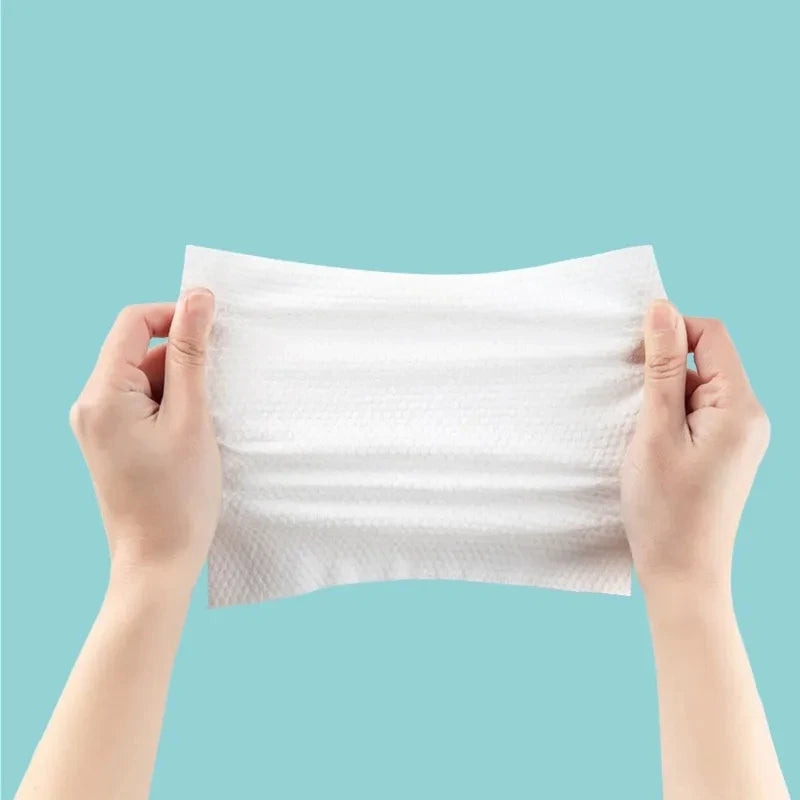 Pack of 70 Cotton Thickened Disposable Face Towel Soft Fabric held stretched by two hands
