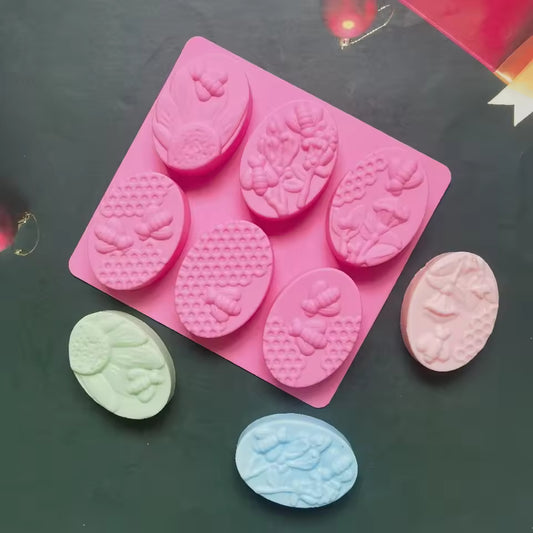 Clarify.pk 6 cavity oval soap mold in pink silicone with floral and butterfly designs for handmade soap crafting