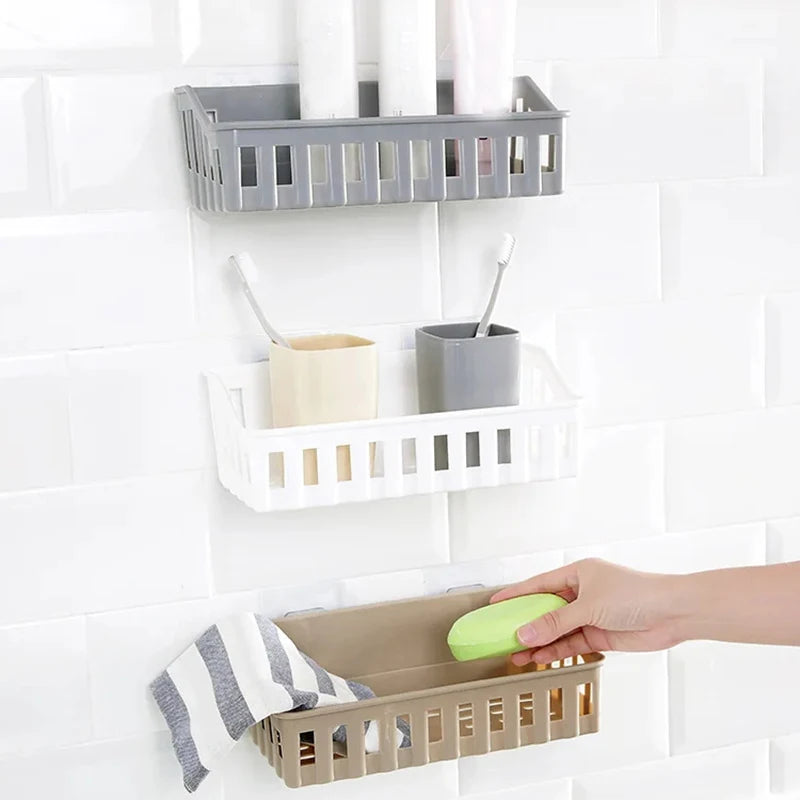 Plastic bathroom shelf organizer set with three wall-mounted baskets holding toiletries and soap