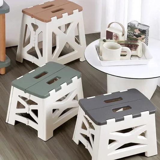 Clarify.pk plastic foldable chair for home use in beige, green, and gray colors near a white table