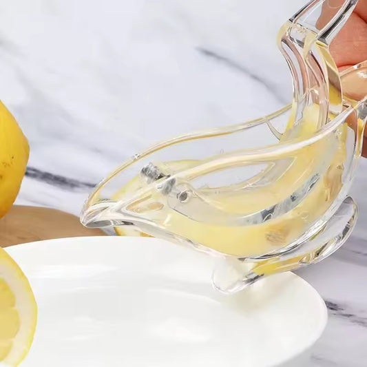 Portable acrylic lemon squeezer extracting fresh lemon juice over a white plate