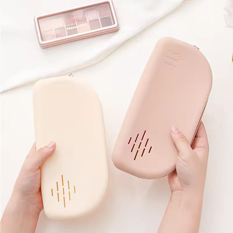 Clarify.pk silicone cosmetic bags in beige and pink as a portable makeup organizer held in hands