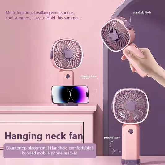 Portable mini fan USB rechargeable in pink with handheld, desktop, and hanging neck modes and mobile phone holder