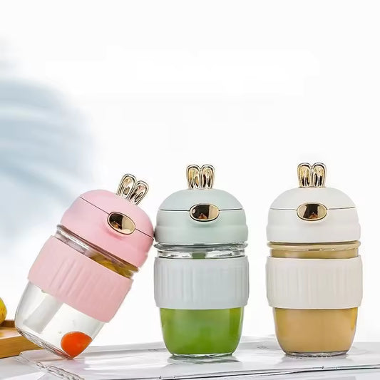 Portable rabbit water bottle set in pink, green, and beige with rabbit ear lids for easy drinking