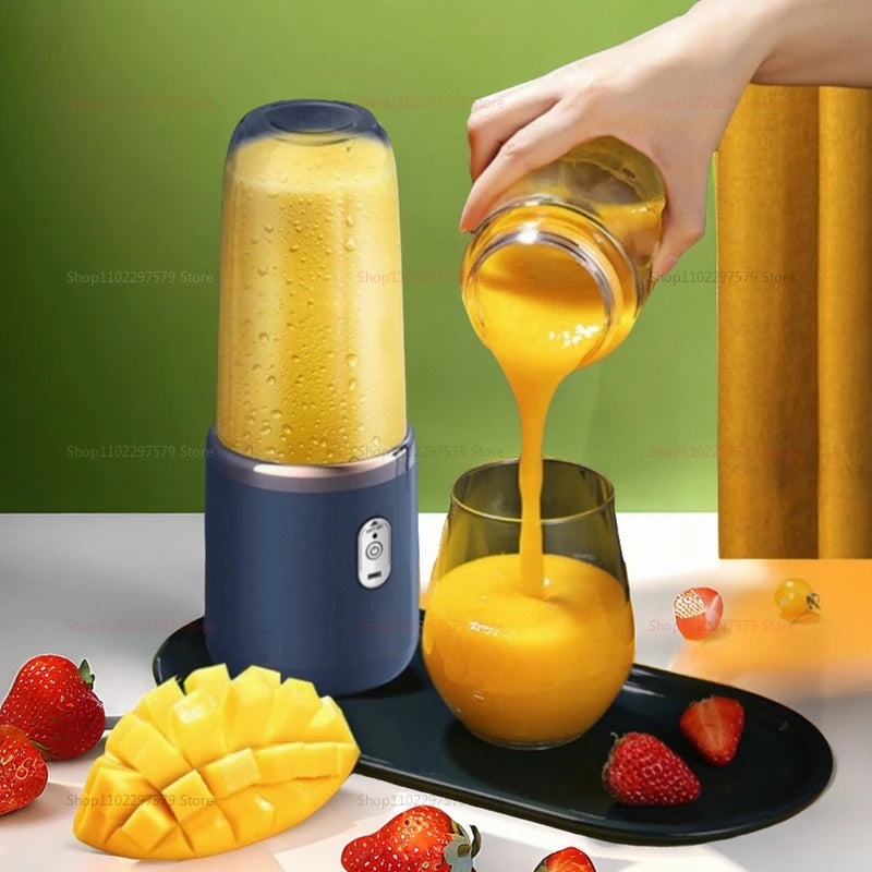 Portable USB juicer blender blending mango smoothie with fresh strawberries and mango slices nearby