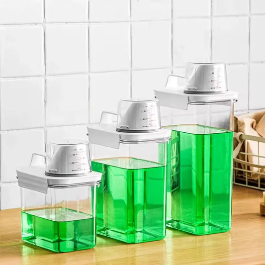 Set of three transparent storage boxes with white lids filled with green liquid portable washing powder dispenser