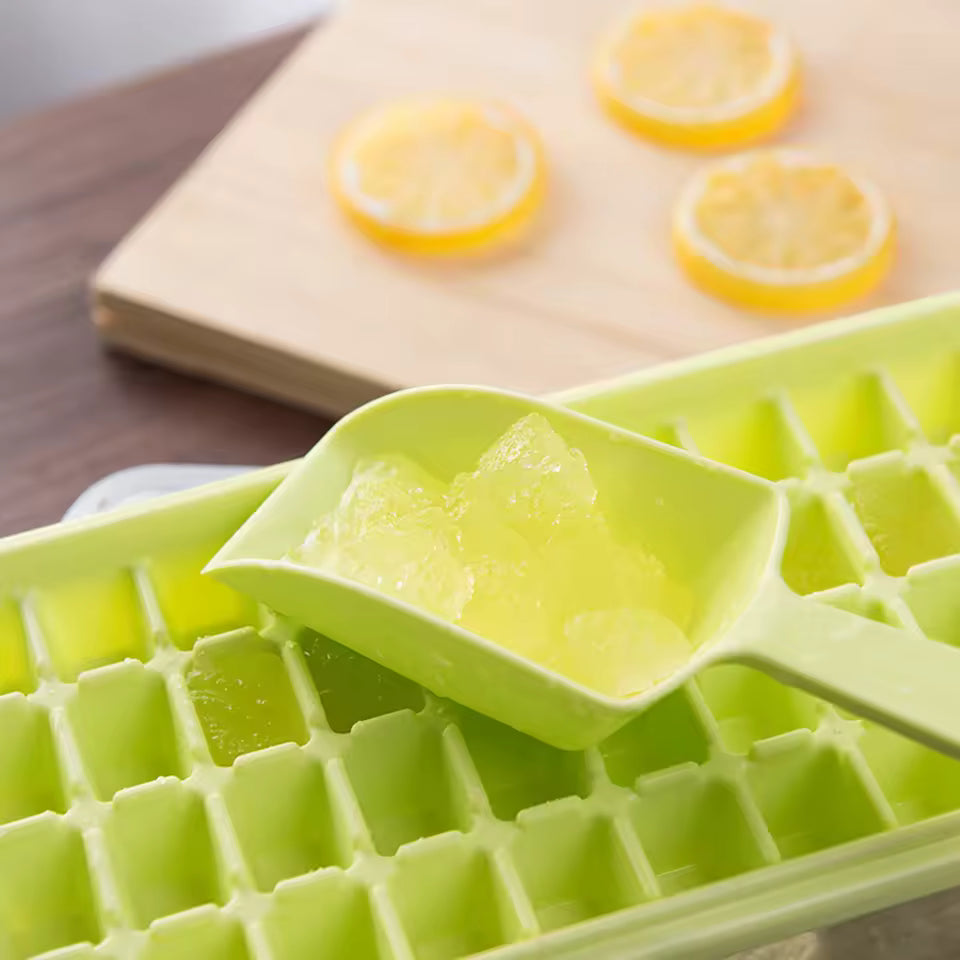 Green premium plastic 36 grid ice cube tray with ice cubes and scoop closeup