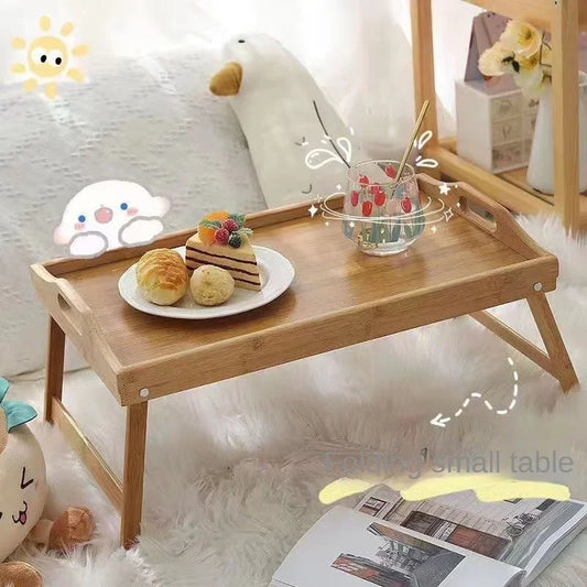 Clarify.pk premium quality natural bamboo table with foldable legs holding snacks and a glass in a cozy room