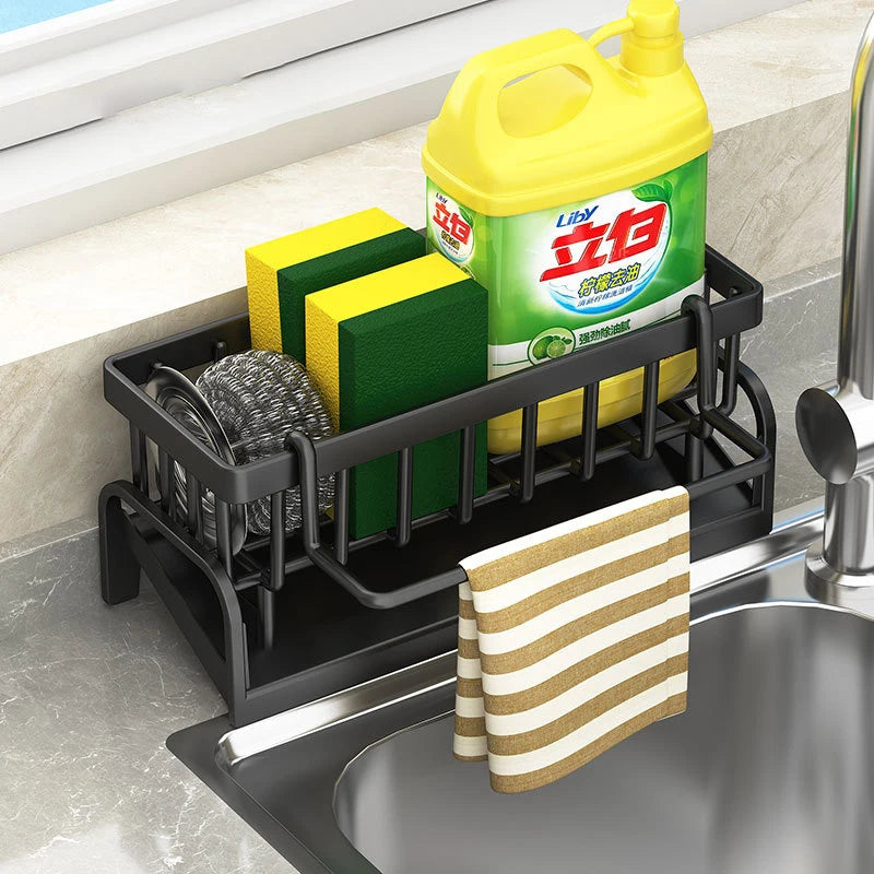 Clarify.pk sink drain rack with premium stainless steel sponge holder, yellow detergent and sponges on kitchen sink