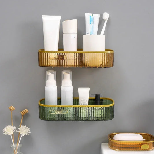 Clarify.pk plastic punch-free bathroom shelf in gold and green with toiletries on gray wall