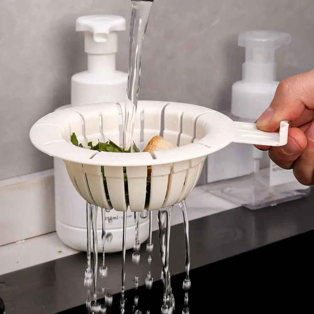 White rabbit drain basket strainer catching food debris under running water in kitchen sink