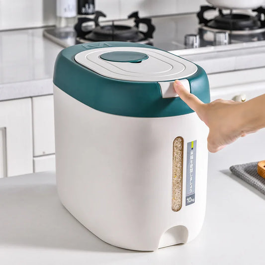 White and green rice storage container with airtight lid being opened by hand in kitchen