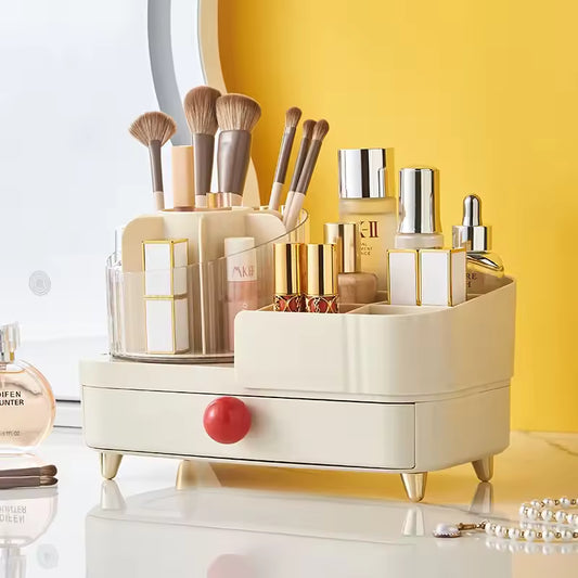 Elegant jewelry and makeup organizer box with multiple compartments holding brushes, bottles, and lipsticks on a vanity table