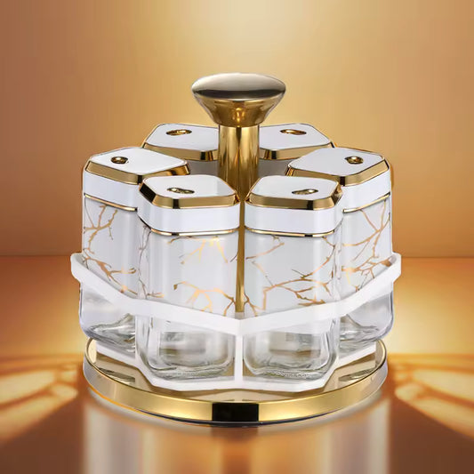 Clarify.pk rotating spice jar set with gold accents and marble design on a gold base