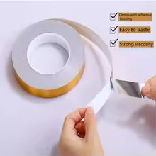 Roll of white tape being cut by hand with self adhesive tile stickers for easy paste and strong viscosity