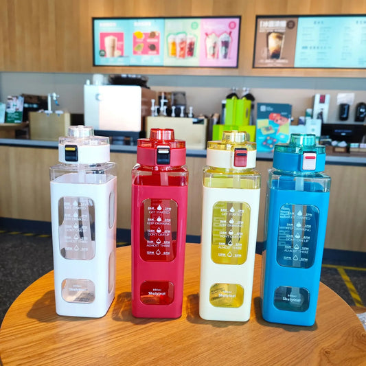 Colorful 900ml leak proof water bottle set in white red yellow and blue on wooden table