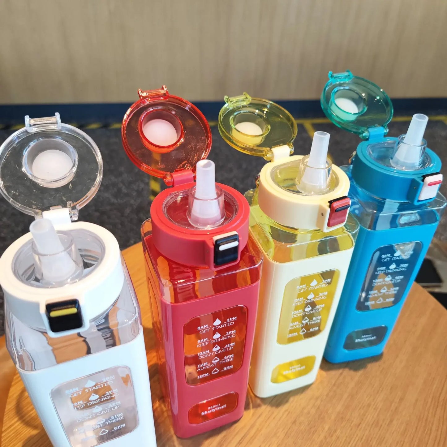 Clarify.pk 900ml leak proof water bottle in white red yellow and blue with flip top and sip straw