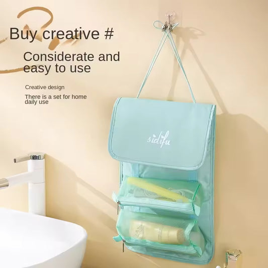 Light blue detachable hangable toiletry bag with multiple compartments hanging near bathroom sink