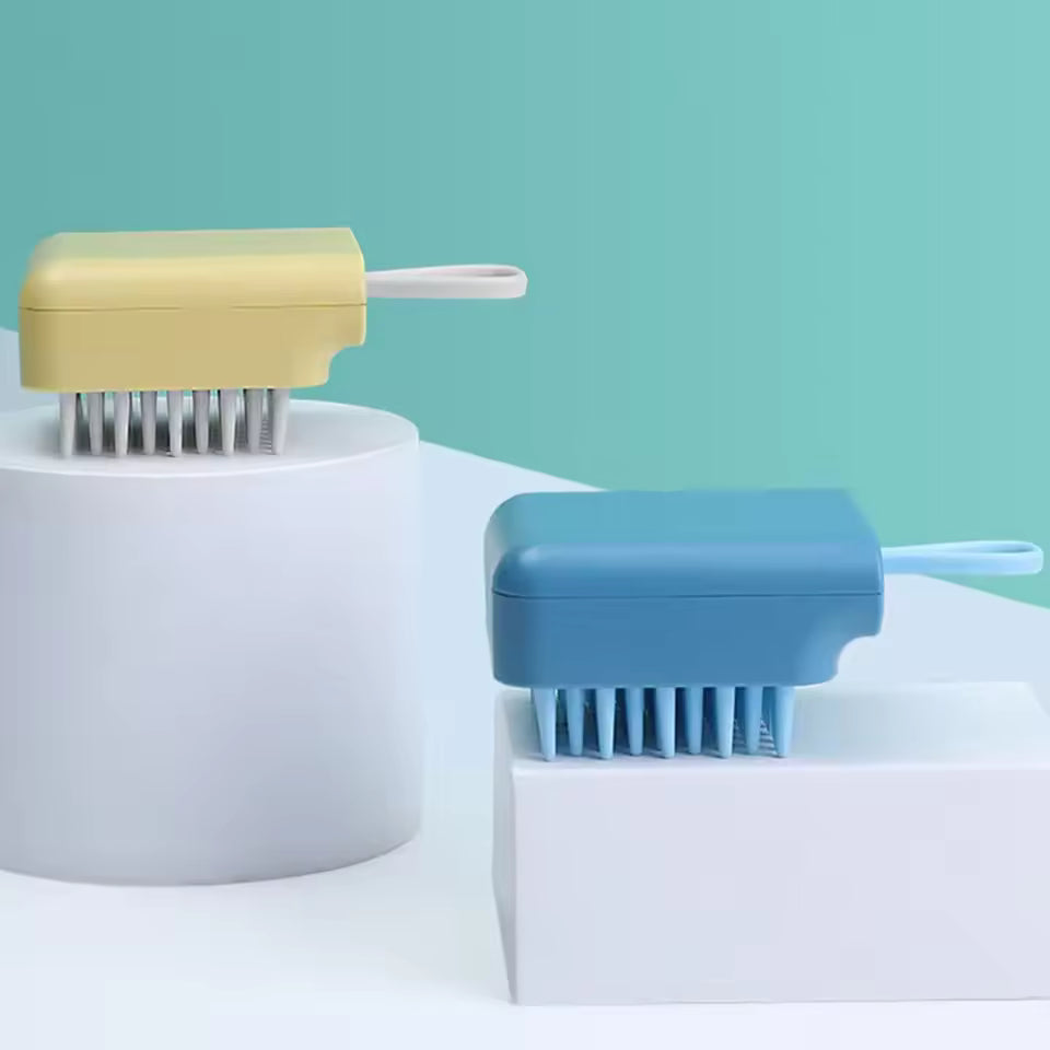 Yellow and blue silicone head massager brush with ergonomic handles placed on white geometric platforms