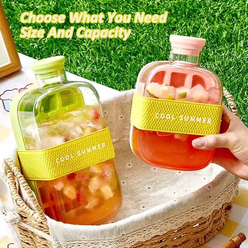 Two glass bottles filled with iced beverages holding silicone ice cube tray with straw ice cubes in basket