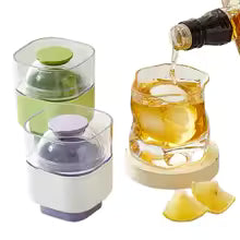 Silicone sphere ice mold set by Clarify.pk with two molds and whiskey glass with ice and lemon wedges