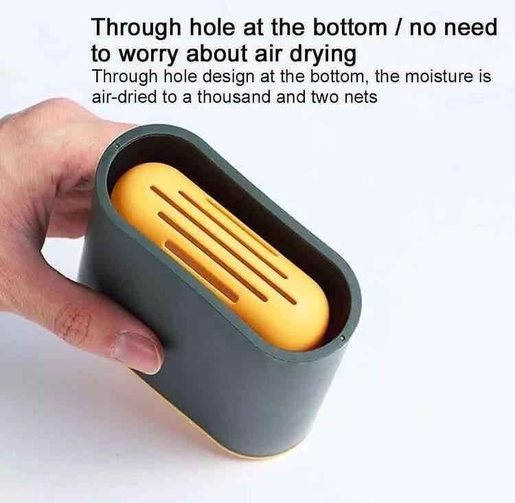 Hand holding gray and yellow silicone toilet brush set with air-drying through hole design