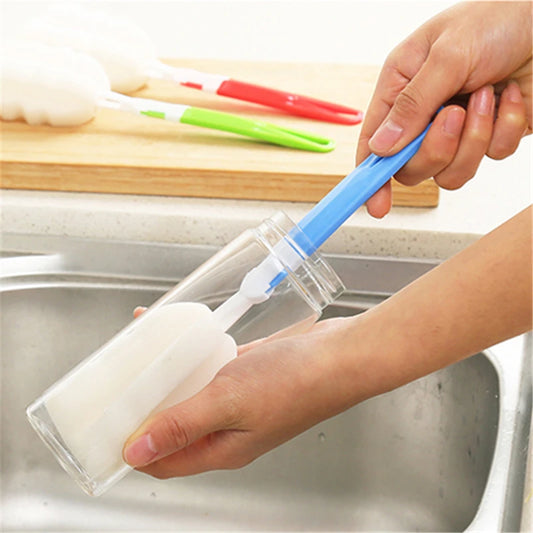 Soft sponge bottle cleaning brush with blue handle cleaning a glass bottle by Clarify.pk