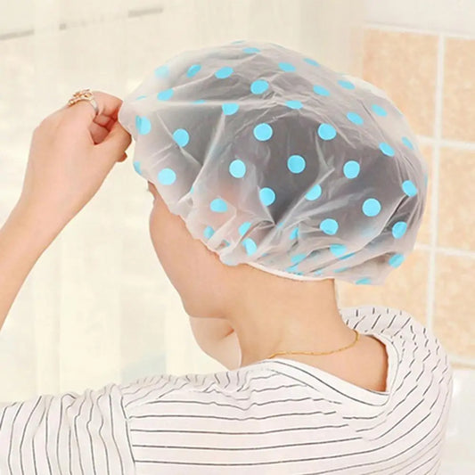 spa hair salon shower cap by Clarify.pk transparent with blue polka dots worn on head