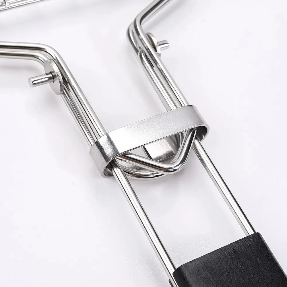 Close-up of stainless steel BBQ grill handle with black grip for safe cooking